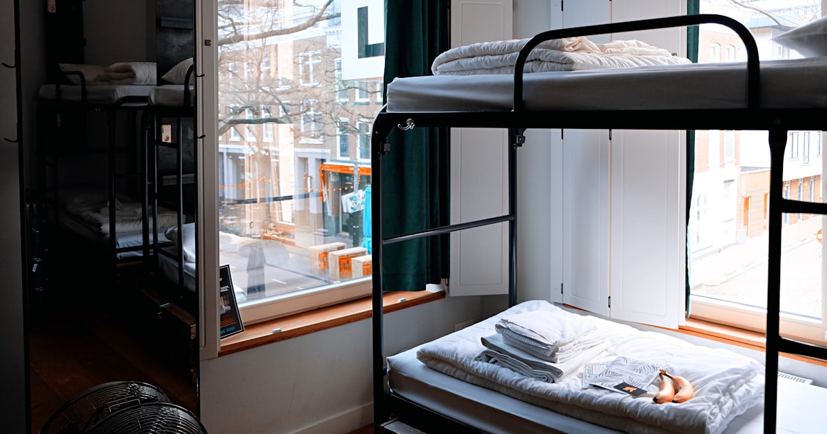 Organized dorm room with desk, bed, and storage